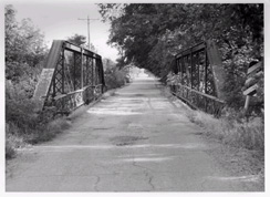 black and white photo of a wooden bridge