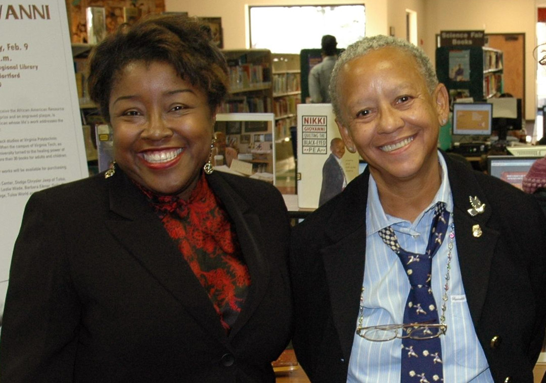 Two women standing together smiling