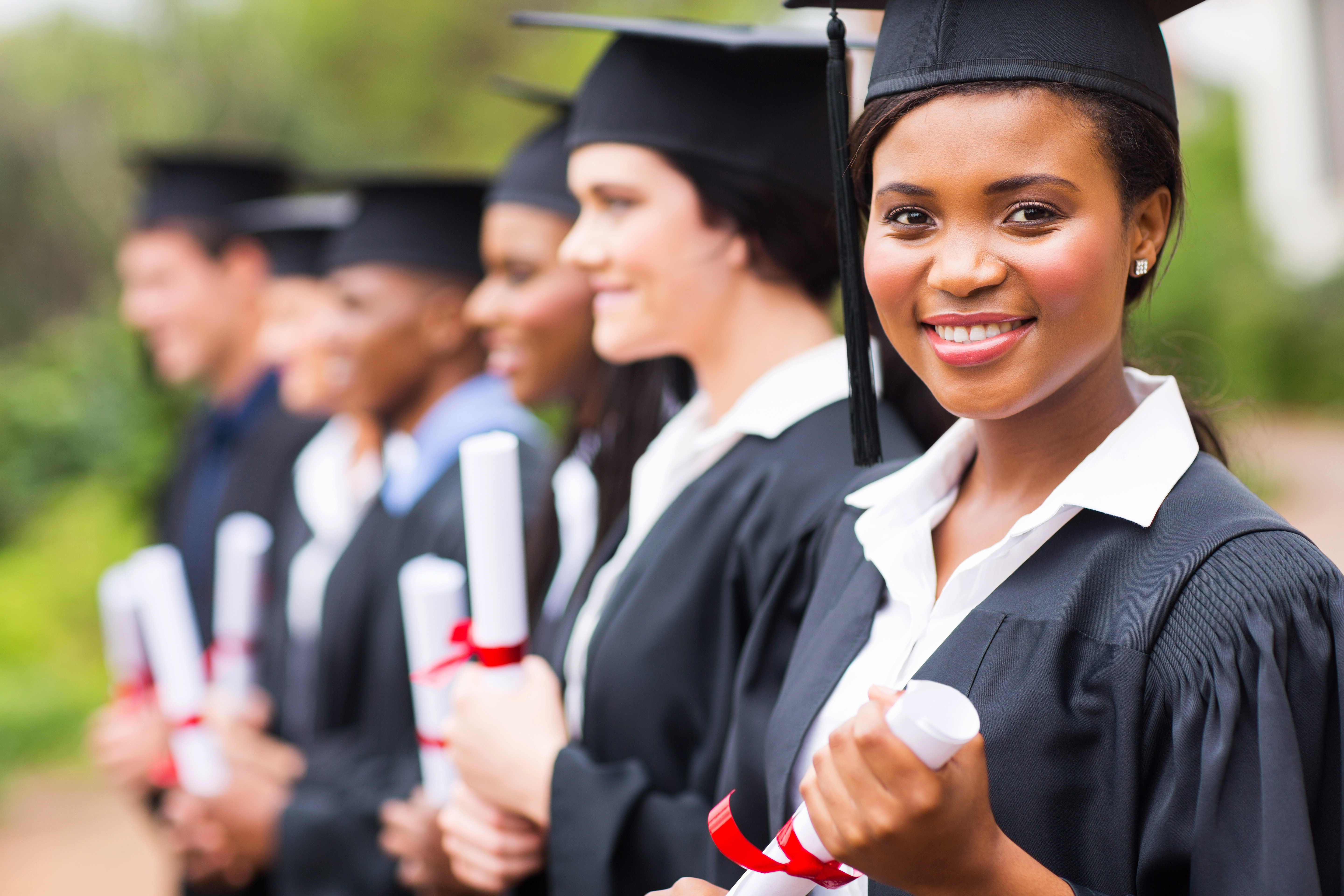 Graduates holding diplomas
