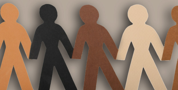 Paper dolls in different skin tone colors against a grey backdrop.