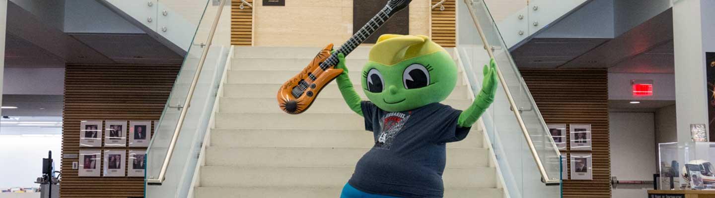 Buddy Bookworm mascot at Central Library staircase