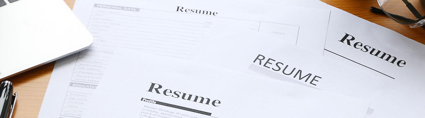 several resume papers on a desk