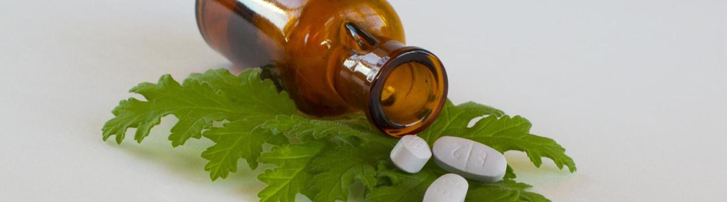 pill bottle on top of green leaf