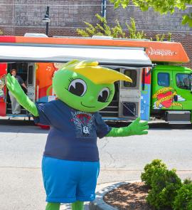 Buddy Bookworm in from of the Bookmobile