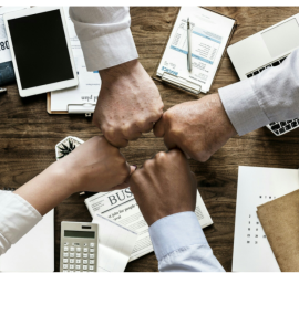 four coworkers fist bump