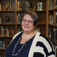 Heather in front of a bookshelf